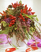 Autumnal arrangement of heather and ornamental peppers