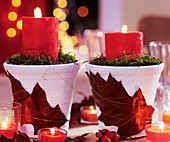 Pots with leaf decoration and red candles