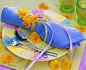 Plate decoration with pale-blue napkin and pansies