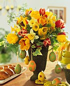 Arrangement of tulips, daffodils & eggs; Easter plait 