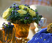 Arrangement of roses and forget-me-nots with sisal