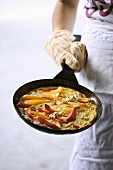 Frittata with peppers and feta in frying pan