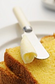 Butter cake with butter curl and knife
