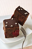 Two squares of chocolate raspberry cake