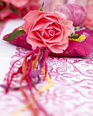 Pink rose on silk cushion