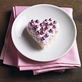 Heart-shaped sponge cake with strawberry cream and dragees
