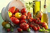 Various types of tomatoes with a colander