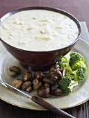 Cheese fondue with mushrooms and broccoli