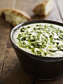 Cheese sauce with basil oil and white bread
