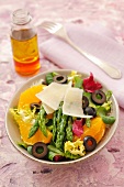 Green asparagus with Parmesan on orange and olive salad