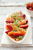 Smoked salmon with strawberries, rocket and green peppercorns