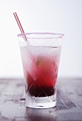 A glass of Cassis lemonade with sugared rim and straw