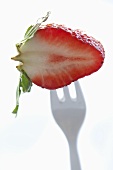 Half a strawberry on fork