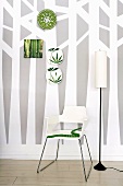 Wallpaper with tree design, chair, standard lamp