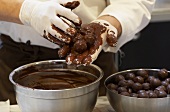 Rolling chocolates in melted chocolate