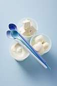 Yoghurt, feta and mozzarella in plastic pots