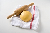 Ball of pasta dough with rolling pin