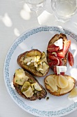 Crostini topped with tomatoes, goat's cheese, onion and courgette