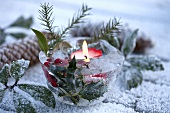 Ice bowl with holly and candle (Christmas decoration for garden)