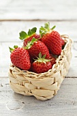 Several strawberries in small basket