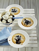 Blueberry almond puddings baked in plates, yoghurt ice cream