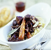 Wild boar with vegetables in red wine sauce
