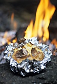 Baked potato in front of open fire