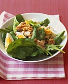 Spinach salad with boiled egg and walnuts