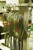Several whisks in a commercial kitchen