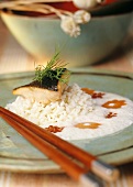 Salmon fillet with rice on coconut foam