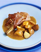 Pork chop wrapped in bacon with potatoes