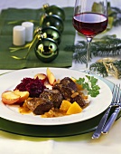 Venison goulash with peach sauce and caramelised apples