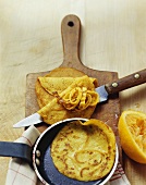 Cutting orange pancakes into strips