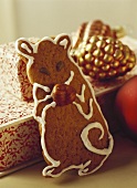 Gingerbread mouse in front of Christmas decorations