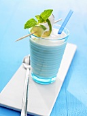 Coconut shake with coconut and lime on cocktail stick