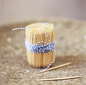 A bundle of toothpicks tied with kitchen string