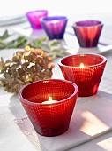 Tea lights in coloured glasses