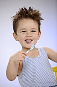Small boy with yoghurt spoon in his hand
