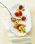 Skewered chicken breast and onions with cocktail tomatoes