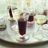 Glasses of red and white wine on tray
