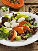Salad leaves with papaya and goat's cheese