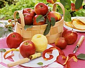 Apples in woodchip basket and on plate with apple corer