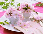 Ornamental cherry blossom in cup and eggcup