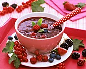 Red berry compote garnished with fresh berries