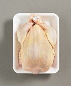 Whole chicken on plastic tray
