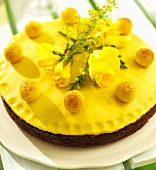 Simnel cake with yellow freesias for Easter