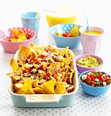 Nachos with salsa and guacamole, orange juice