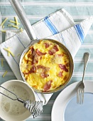 Ham and cheese omelette in frying pan