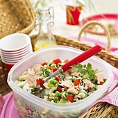 Rice and vegetable salad with salmon for a picnic