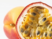 Passion fruit in front of apricot (close-up)